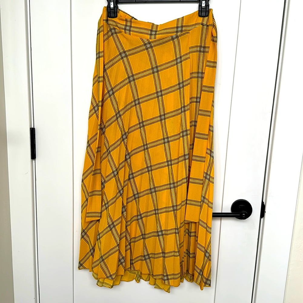 Pleated, below-the-knee skirt w/ribbon-bow wrap detail. Yellow, tartan pattern.